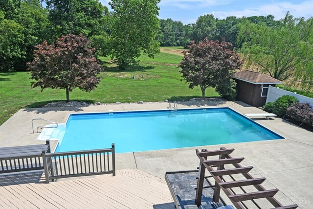 8424 Oak Grove Rd, Georgetown, OH 45121 - swimming pool featuring a yard, a patio, a storage unit, and a diving board