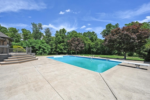 8424 Oak Grove Rd, Georgetown, OH 45121 - outdoor pool featuring a diving board, a patio, and view of wooded area