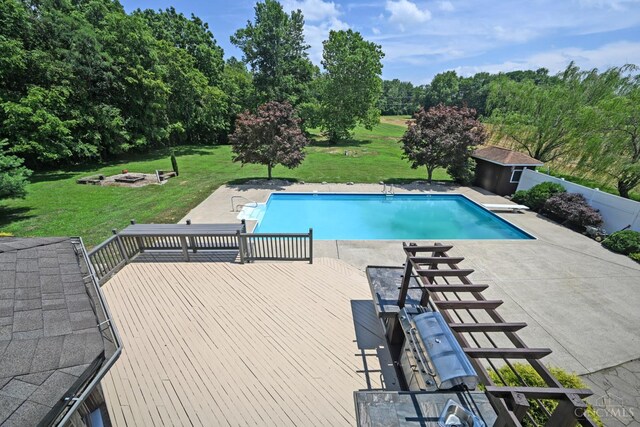 8424 Oak Grove Rd, Georgetown, OH 45121 - swimming pool featuring a yard, a deck, a patio area, a fire pit, and a diving board