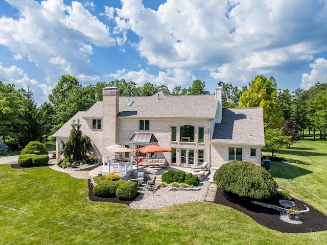 8069 Green Lake Dr, Liberty Twp, OH 45044 - rear view of house with a patio area, a chimney, a yard, and brick siding