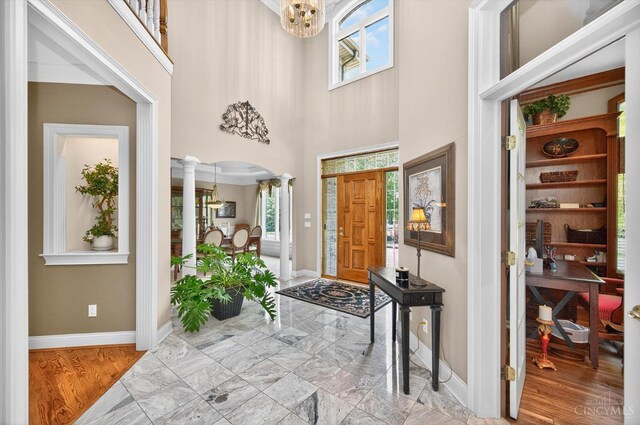 8069 Green Lake Dr, Liberty Twp, OH 45044 - foyer entrance with plenty of natural light, arched walkways, a chandelier, a towering ceiling, and ornate columns