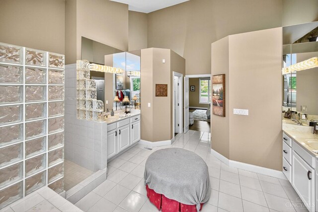 8069 Green Lake Dr, Liberty Twp, OH 45044 - bathroom with a high ceiling, a walk in shower, two vanities, and tile patterned floors