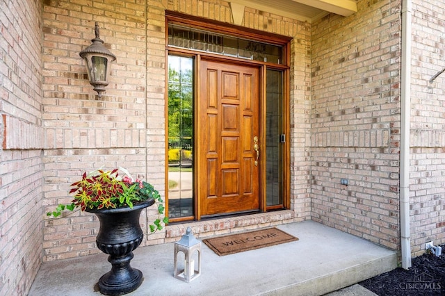8069 Green Lake Dr, Liberty Twp, OH 45044 - doorway to property featuring brick siding and covered porch