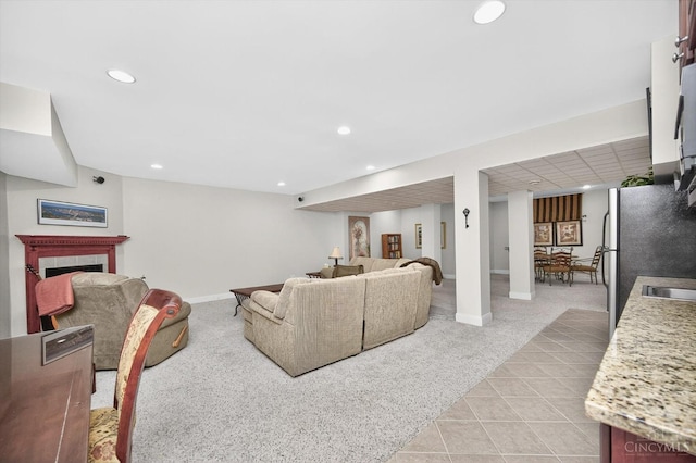 8069 Green Lake Dr, Liberty Twp, OH 45044 - living area with light colored carpet, recessed lighting, light tile patterned flooring, and a tiled fireplace