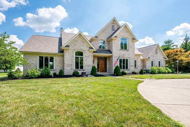 8069 Green Lake Dr, Liberty Twp, OH 45044 - french provincial home with brick siding, a front lawn, and a chimney