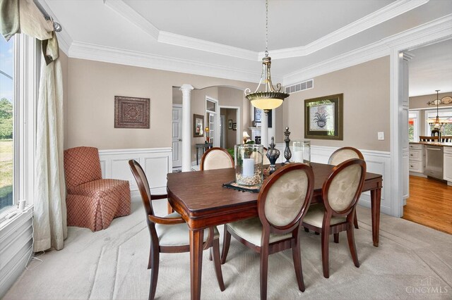 8069 Green Lake Dr, Liberty Twp, OH 45044 - dining area featuring ornate columns, wainscoting, a decorative wall, ornamental molding, and a tray ceiling