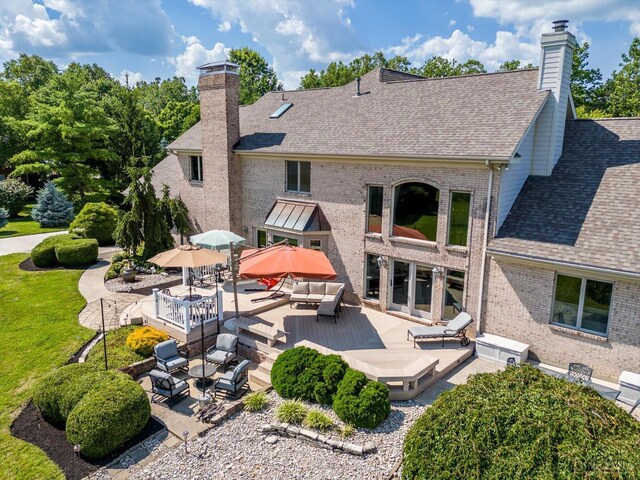 8069 Green Lake Dr, Liberty Twp, OH 45044 - back of house featuring a chimney, outdoor lounge area, a deck, brick siding, and roof with shingles