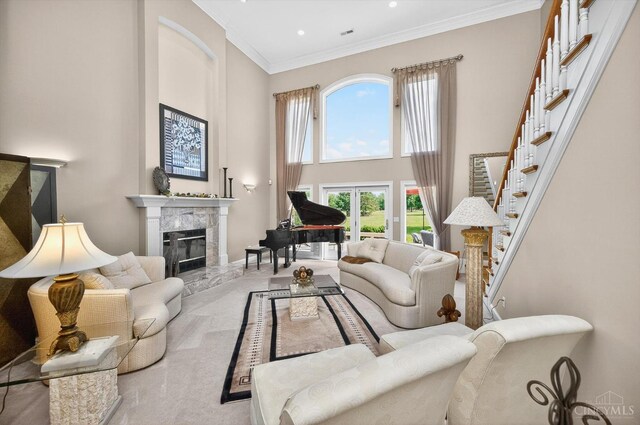 8069 Green Lake Dr, Liberty Twp, OH 45044 - living room with a high ceiling, a premium fireplace, ornamental molding, stairs, and recessed lighting