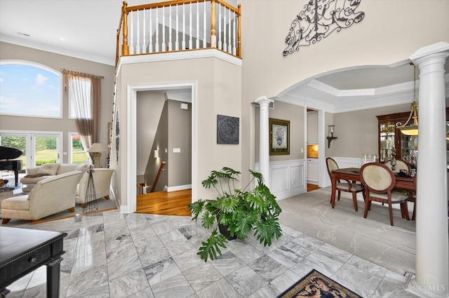 8069 Green Lake Dr, Liberty Twp, OH 45044 - foyer entrance with decorative columns, crown molding, light marble finish floors, arched walkways, and wainscoting