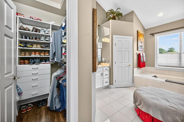 8069 Green Lake Dr, Liberty Twp, OH 45044 - full bath with vanity, a garden tub, tile patterned flooring, a walk in closet, and lofted ceiling