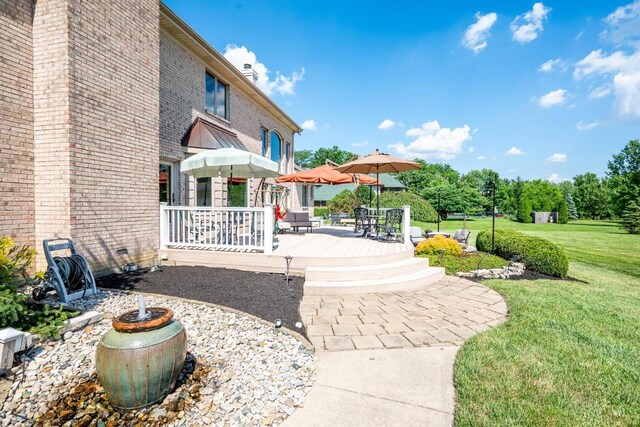 8069 Green Lake Dr, Liberty Twp, OH 45044 - view of community with a lawn, a deck, and outdoor dining space