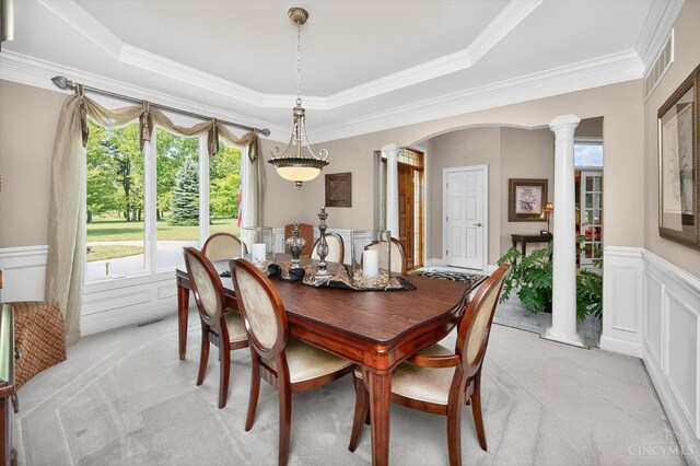 8069 Green Lake Dr, Liberty Twp, OH 45044 - dining space featuring decorative columns, light carpet, a wainscoted wall, crown molding, and a raised ceiling