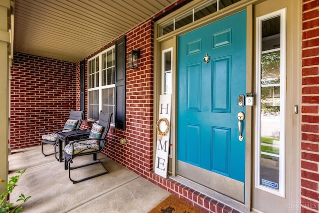 1820 Meadow Sweet Dr, Turtle Creek Twp, OH 45036 - doorway to property with covered porch and brick siding
