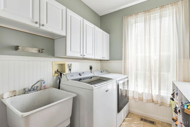 1820 Meadow Sweet Dr, Turtle Creek Twp, OH 45036 - washroom with cabinet space, washer and dryer, wainscoting, and light tile patterned floors