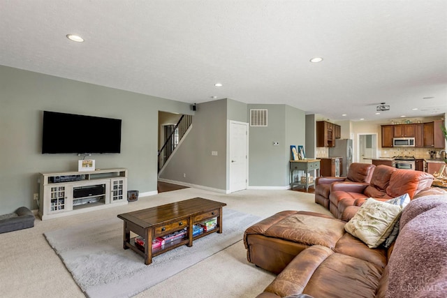 1820 Meadow Sweet Dr, Turtle Creek Twp, OH 45036 - living area with light colored carpet, recessed lighting, and stairs