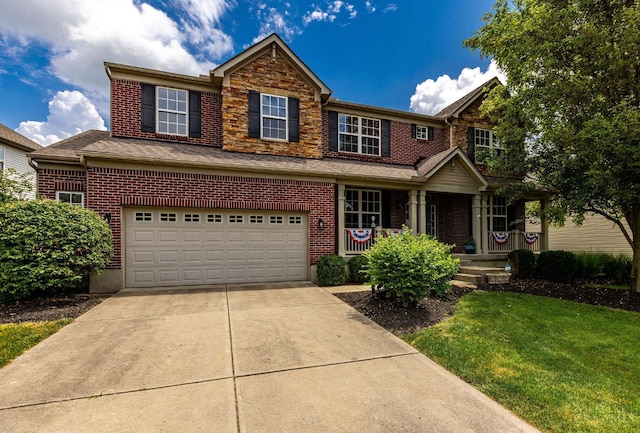 1820 Meadow Sweet Dr, Turtle Creek Twp, OH 45036 - traditional-style home with a porch, concrete driveway, a garage, a front yard, and brick siding