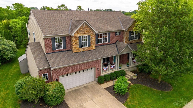 1820 Meadow Sweet Dr, Turtle Creek Twp, OH 45036 - view of front of house featuring driveway, brick siding, a shingled roof, a garage, and a front lawn