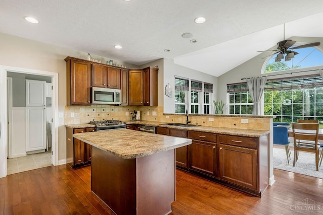 1820 Meadow Sweet Dr, Turtle Creek Twp, OH 45036 - kitchen featuring appliances with stainless steel finishes, a peninsula, dark wood-style flooring, a ceiling fan, and lofted ceiling
