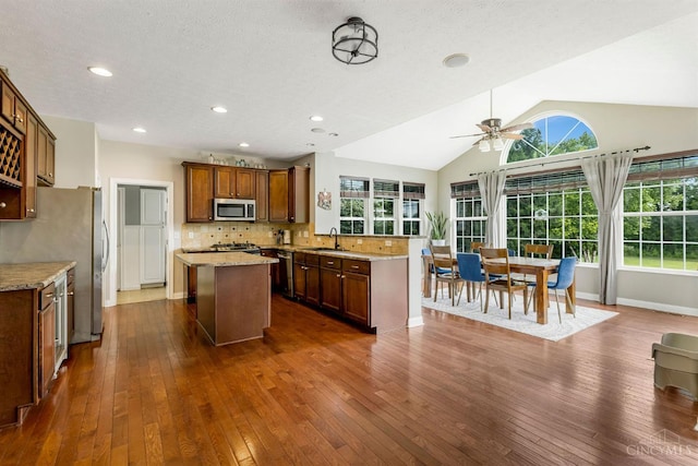 1820 Meadow Sweet Dr, Turtle Creek Twp, OH 45036 - kitchen featuring appliances with stainless steel finishes, a center island, dark wood-type flooring, a peninsula, and a ceiling fan
