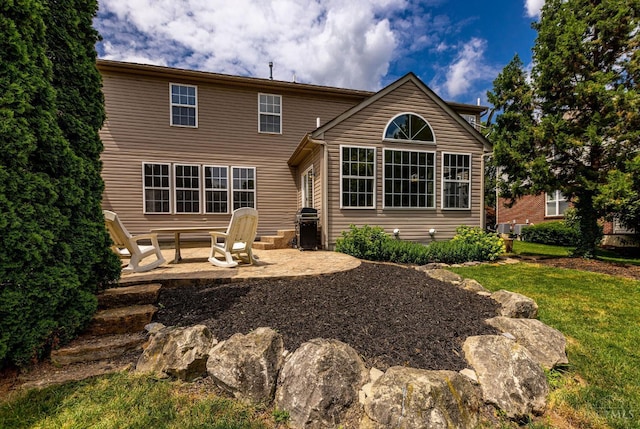 1820 Meadow Sweet Dr, Turtle Creek Twp, OH 45036 - back of house featuring a patio area and a lawn