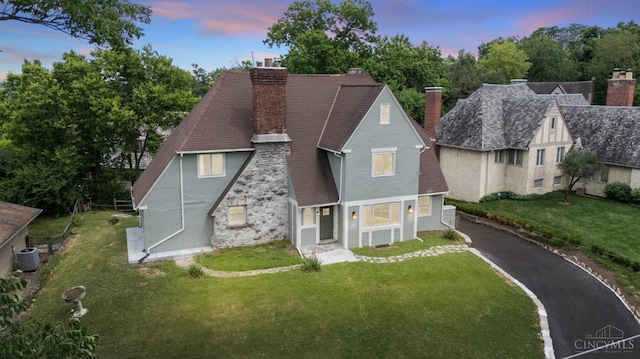 4150 Paddock Rd, Cincinnati, OH 45229 - view of front of property featuring a chimney, stucco siding, a shingled roof, and a front yard