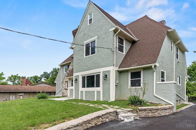 4150 Paddock Rd, Cincinnati, OH 45229 - rear view of house featuring stucco siding, a yard, and a shingled roof