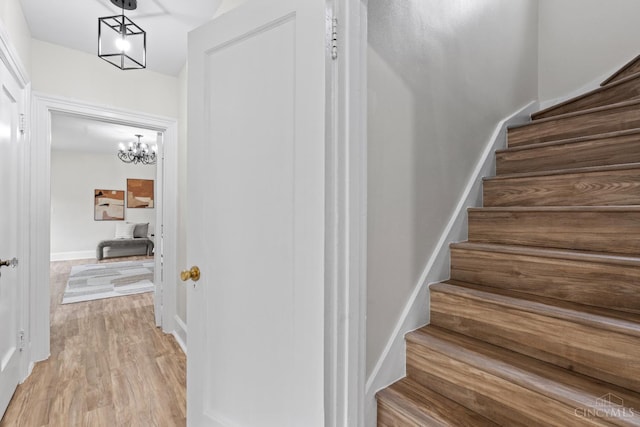 4150 Paddock Rd, Cincinnati, OH 45229 - stairs featuring a chandelier and wood finished floors