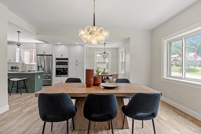 4150 Paddock Rd, Cincinnati, OH 45229 - dining area featuring a chandelier, light wood-type flooring, and recessed lighting
