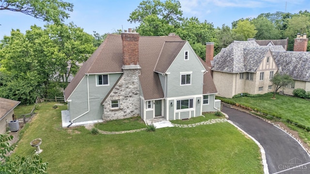 4150 Paddock Rd, Cincinnati, OH 45229 - view of front of property with stucco siding, a chimney, roof with shingles, and a front yard