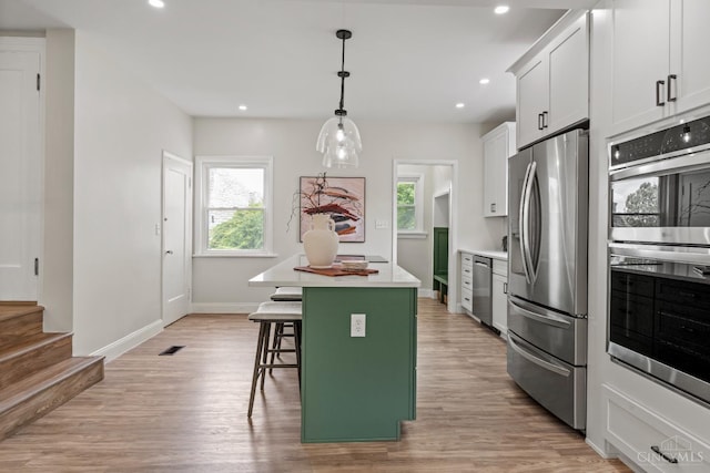 4150 Paddock Rd, Cincinnati, OH 45229 - kitchen featuring stainless steel appliances, healthy amount of natural light, a kitchen island, light wood-style floors, and recessed lighting