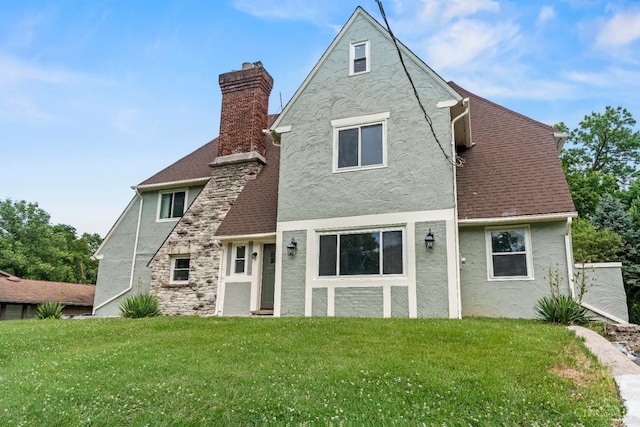 4150 Paddock Rd, Cincinnati, OH 45229 - rear view of house with stucco siding, a yard, and a chimney