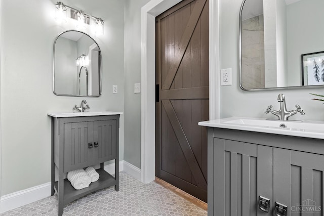 4150 Paddock Rd, Cincinnati, OH 45229 - full bathroom featuring two vanities and baseboards