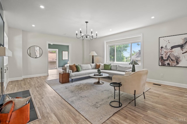 4150 Paddock Rd, Cincinnati, OH 45229 - living room with a chandelier, light wood-type flooring, and recessed lighting