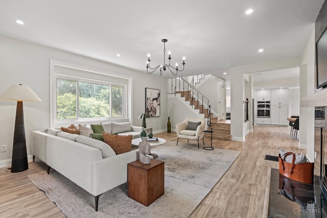 4150 Paddock Rd, Cincinnati, OH 45229 - living room with stairs, a chandelier, light wood-style flooring, and recessed lighting