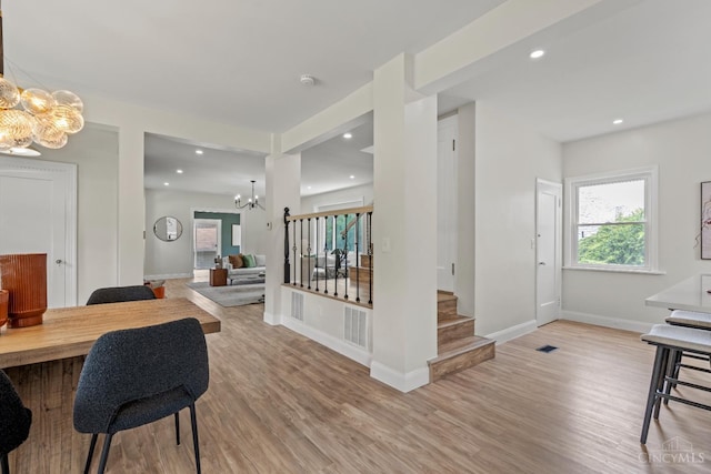 4150 Paddock Rd, Cincinnati, OH 45229 - dining room with a chandelier, light wood-type flooring, stairway, and recessed lighting