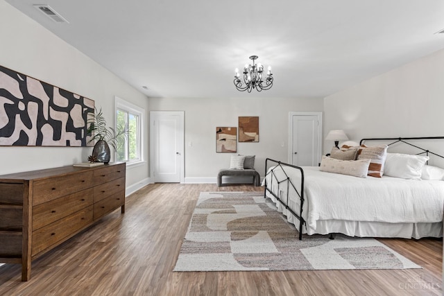 4150 Paddock Rd, Cincinnati, OH 45229 - bedroom with a chandelier and wood finished floors