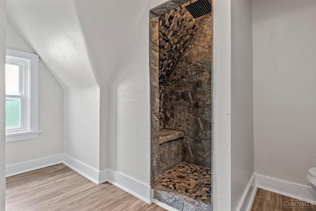 4150 Paddock Rd, Cincinnati, OH 45229 - full bath with tiled shower, wood finished floors, and lofted ceiling