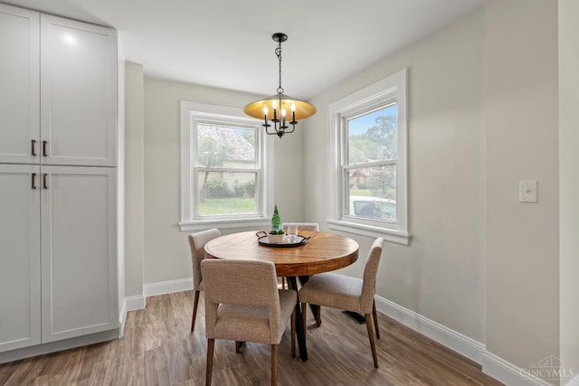 4150 Paddock Rd, Cincinnati, OH 45229 - dining room with a chandelier, wood finished floors, and plenty of natural light