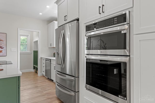 4150 Paddock Rd, Cincinnati, OH 45229 - kitchen featuring appliances with stainless steel finishes, light wood-type flooring, white cabinets, light countertops, and recessed lighting