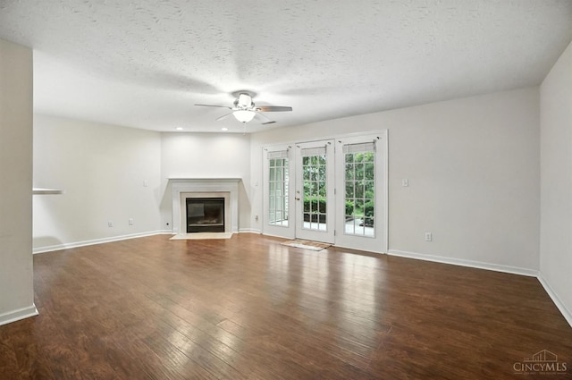 5433 Harbourwatch Unit 104, Deerfield Twp, OH 45040 - unfurnished living room with a ceiling fan, a fireplace with flush hearth, wood finished floors, and a textured ceiling