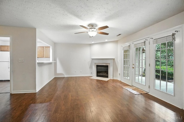 5433 Harbourwatch Unit 104, Deerfield Twp, OH 45040 - unfurnished living room featuring ceiling fan, hardwood / wood-style floors, a fireplace with flush hearth, and a textured ceiling