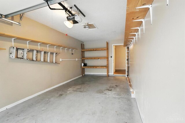 5433 Harbourwatch Unit 104, Deerfield Twp, OH 45040 - garage featuring baseboards and a garage door opener
