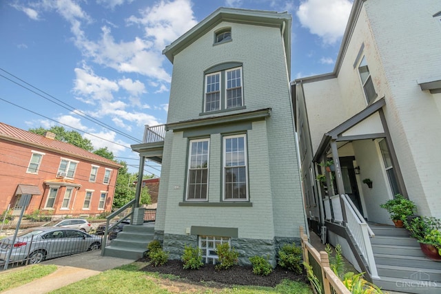 1419 Chase Ave, Cincinnati, OH 45223 - view of front of home featuring brick siding and a balcony
