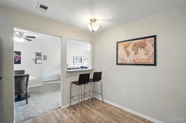 7234 Creekview Dr Unit 1, Colerain Twp, OH 45247 - dining area with wood finished floors, a textured ceiling, and a ceiling fan