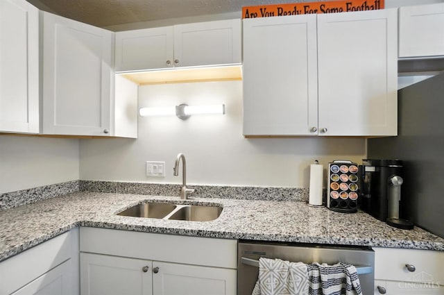 7234 Creekview Dr Unit 1, Colerain Twp, OH 45247 - kitchen with stainless steel dishwasher, white cabinetry, and light stone counters