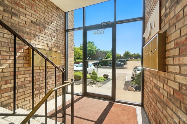 7234 Creekview Dr Unit 1, Colerain Twp, OH 45247 - entryway with brick wall, a towering ceiling, and expansive windows