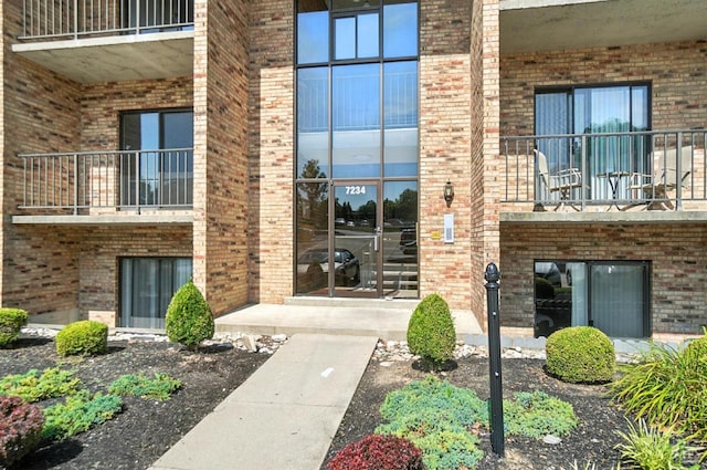 7234 Creekview Dr Unit 1, Colerain Twp, OH 45247 - view of exterior entry featuring a balcony and brick siding