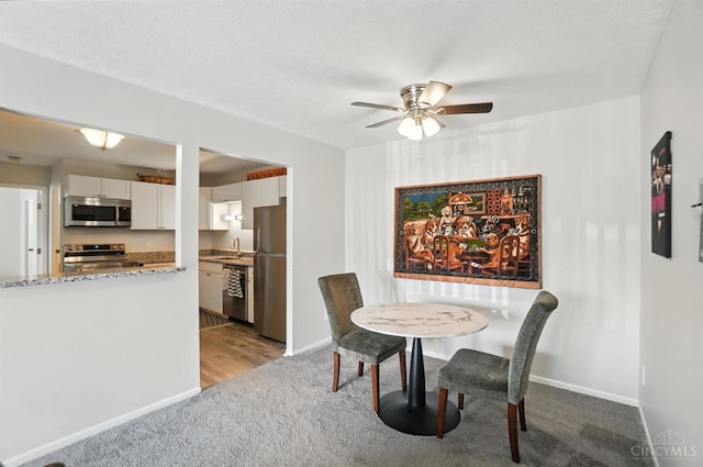 7234 Creekview Dr Unit 1, Colerain Twp, OH 45247 - dining area with light colored carpet and a ceiling fan