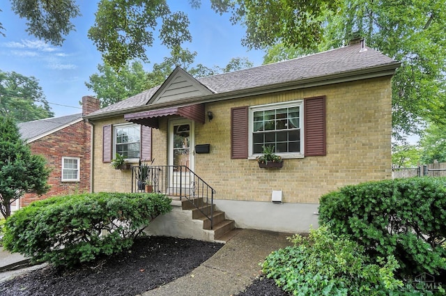 1146 Wilshire Ave, Anderson Twp, OH 45230 - view of front of home featuring a chimney, brick siding, and a shingled roof