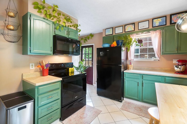 1146 Wilshire Ave, Anderson Twp, OH 45230 - kitchen featuring black appliances, light countertops, light tile patterned flooring, green cabinets, and a textured ceiling